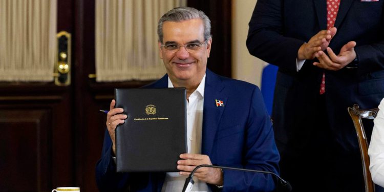 Foto del presidente Luis Abinader mientras firma decréto que regula la publicidad estatal.