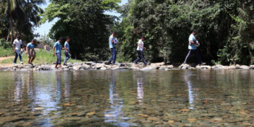 Niños cruzan río a pie para ir a la escuela en La Cuaba